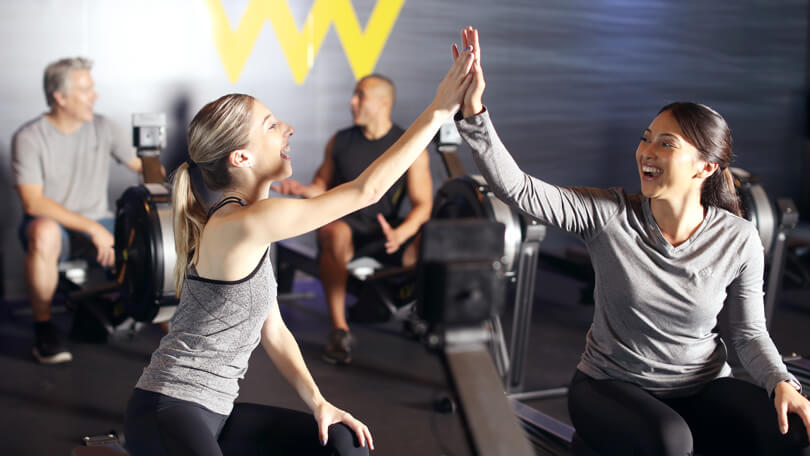 Two people high-fiving at Row House