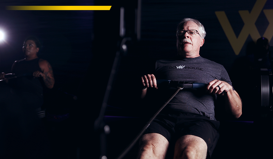 Two people using rowing machines