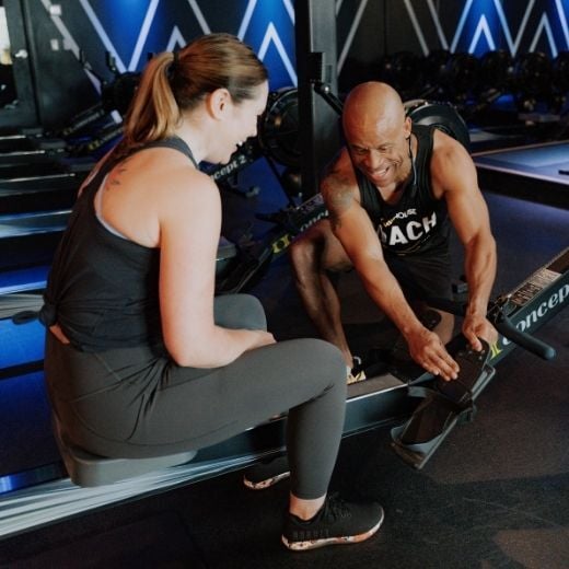 Coach setting up a first time rower