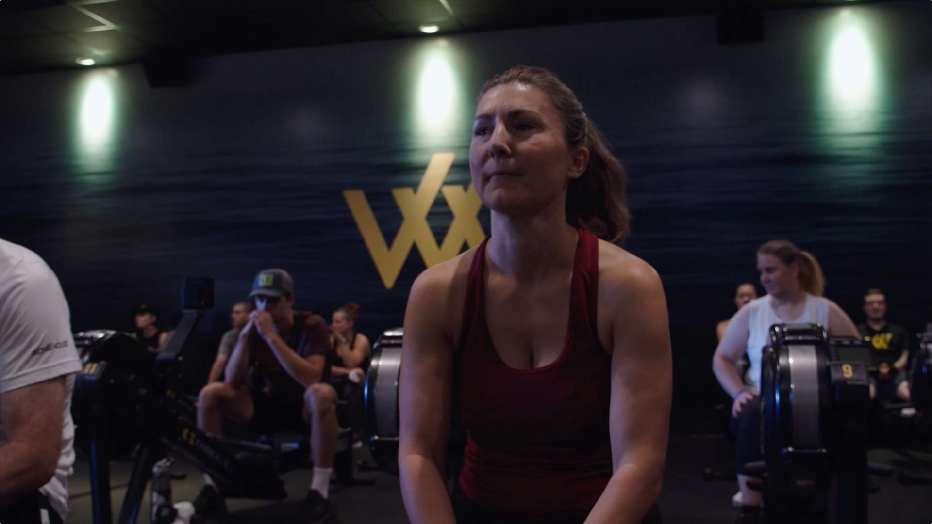 Group sitting on rowing machines